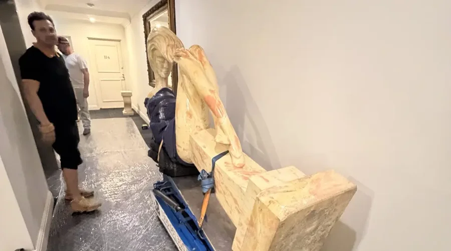 A 700kg marble sculpture mechanically tilted on a JB Removals stair climber inside a protected building corridor