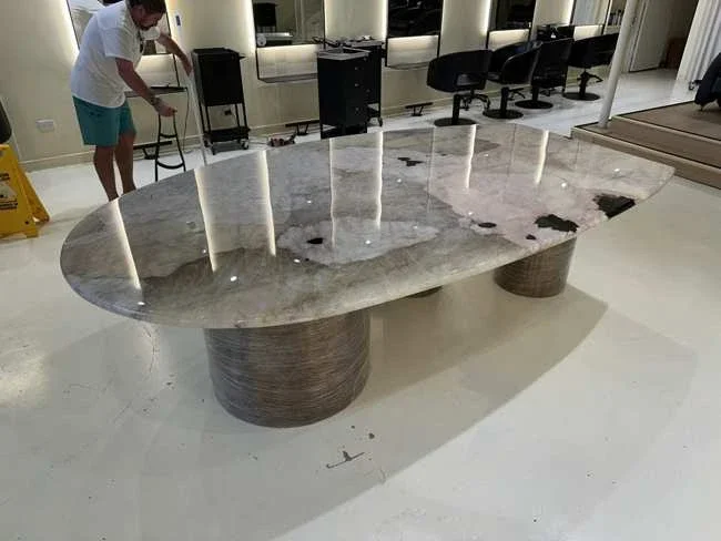Oval marble table positioned inside a Bondi hair salon